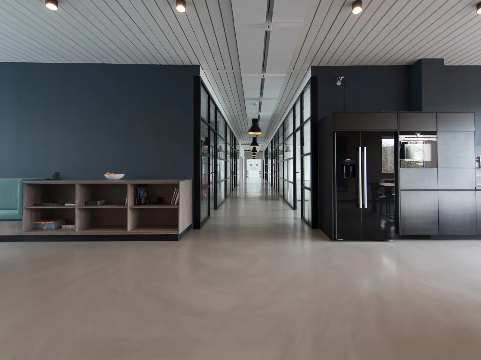 An empty modern office hall — the quiet room where automated work runs.