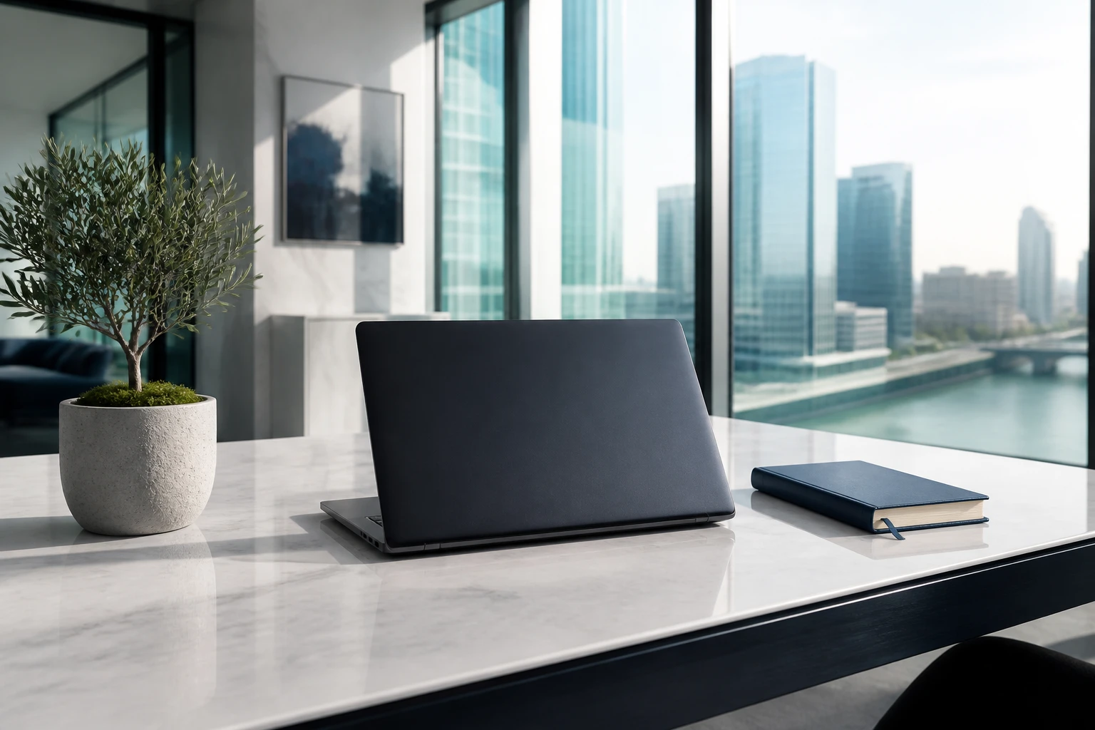 A bright software studio with a laptop and notebook on a white desk — IT services, ready to work.